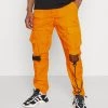 Nuovo di zecca ✔️ Karl Kani SIGNATURE CRINCLE PANTS UNISEX - Pantaloni Cargo - Orange 👏