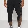 Vendita all'ingrosso 🎁 Karl Kani SMALL SIGNATURE BLEACHED UNISEX - Pantaloni Sportivi - Black 🎉 -Sconto Karl Kani in Italia a2459c64510b47ccbf6f49db8c05bb99